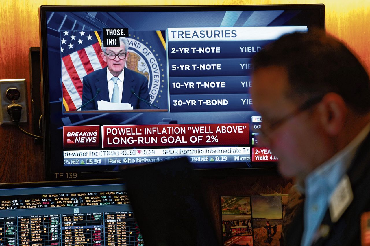Handelaren kijken op de beursvloer naar de persconferentie van Fed-voorzitter Jerome Powell.
