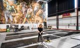 Een schilder verft golfplaten voor het decor van ‘Lohengrin’, in het <strong>decoratelier </strong>van Nationale Opera &amp; Ballet.